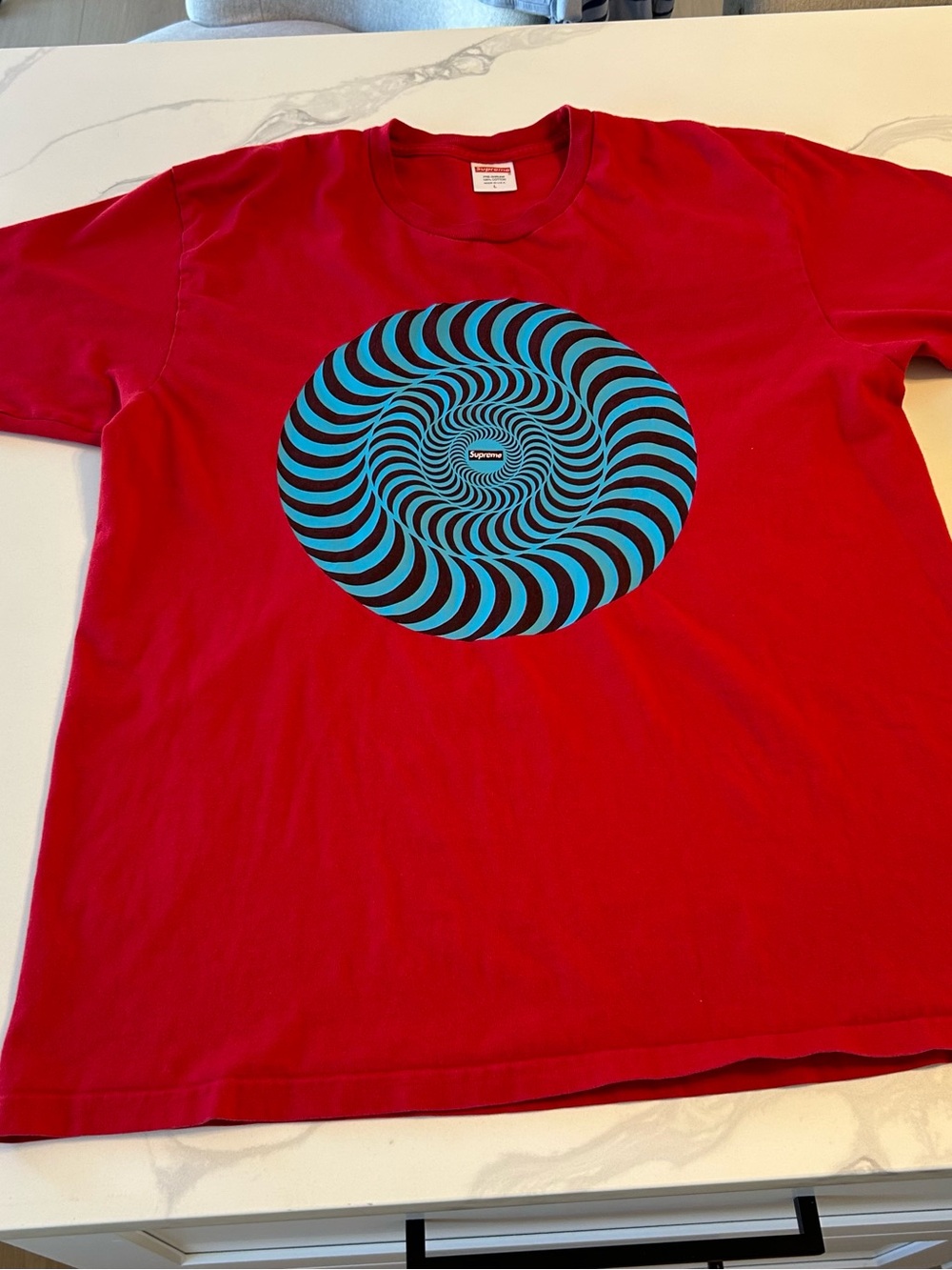 Supreme Spitfire Classic Red Tee with Blue Optical Spiral Graphic. Size Large